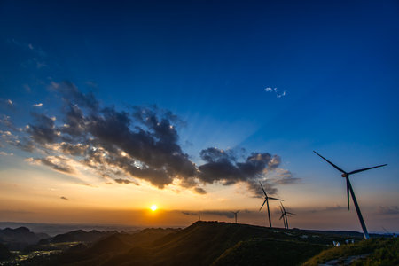 wind turbine at sunset in the mountains, Chengde, Hebei Province, Chinaの写真素材