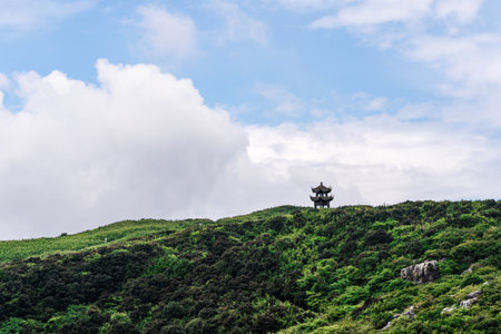 Mountain landscape with a pagoda on the top of a hillの写真素材