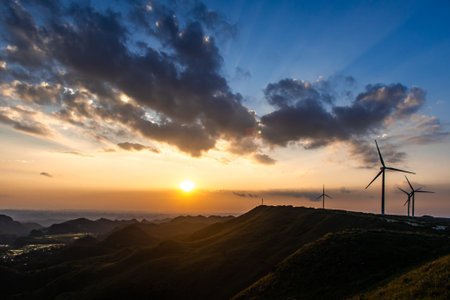 wind turbines at sunset in the mountains, renewable energy, ecology conceptの写真素材