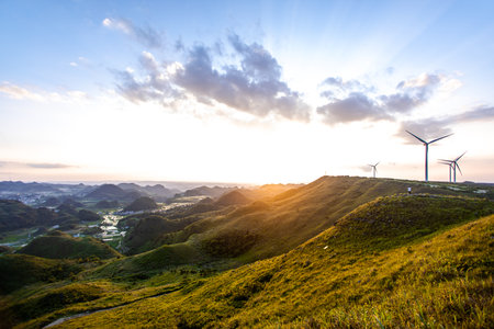 Wind turbines generating electricity on the hill at sunset in Taipei, Taiwanの写真素材
