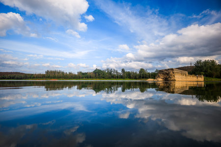Landscape of a lake with blue sky and clouds reflected in waterの写真素材