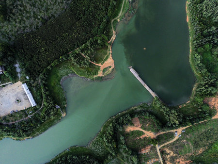 Aerial view of a dam on a lake in the forest.の写真素材