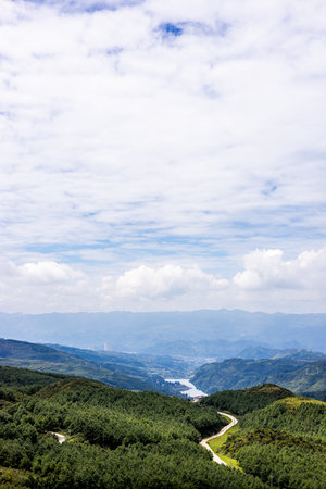 Landscape view of the green mountain and blue sky with white cloudsの写真素材