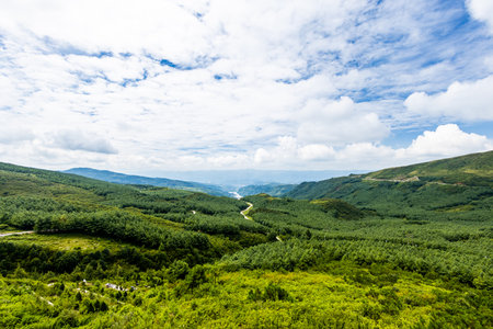 Beautiful landscape of green mountains and blue sky with white clouds.の写真素材