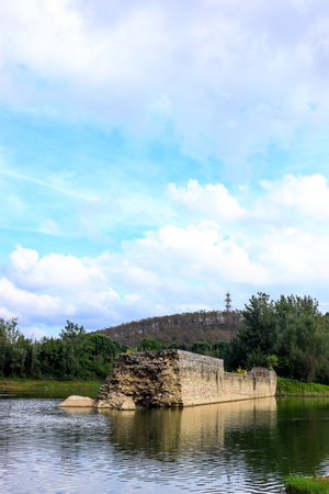The old stone wall of the fortress on the bank of the riverの写真素材
