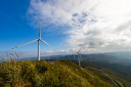 Wind turbine on the top of the mountain with blue sky background.の写真素材