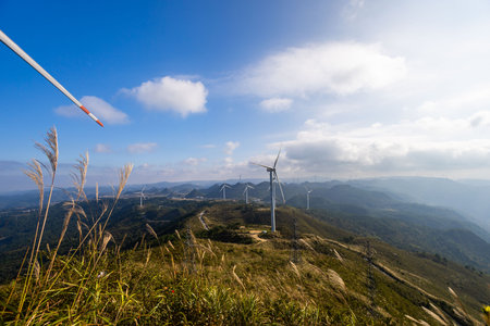 Wind turbines on the mountain with blue sky background, wind power generationの写真素材