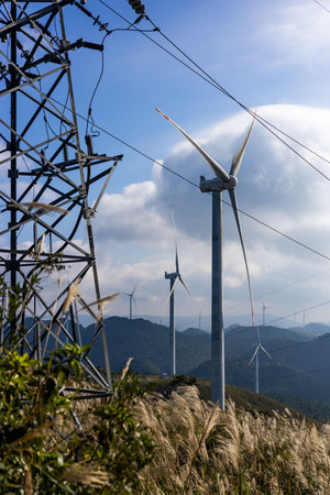 Wind turbines and high voltage power lines on the top of the mountain