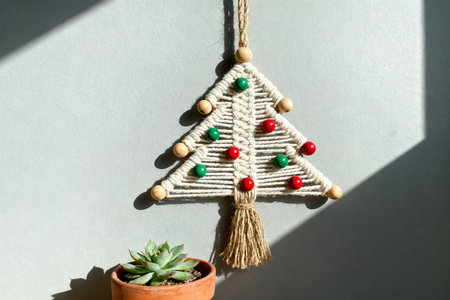 Christmas tree made of wooden beads on white background. New Year decoration.の素材