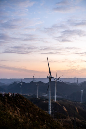 Wind turbines on the mountain at sunset.の写真素材