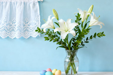 Easter eggs and lily flowers in vase on blue backgroundの素材