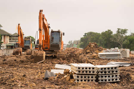Heavy orange machine crawler loader or loader excavator, removing soil from ground  for site...