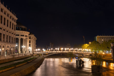 Skopje,North Macedonia,5-1-2023: Illuminated Art bridge of the Skopje Most na umetnosta at night with lighted lamps on the river Vardarのeditorial素材
