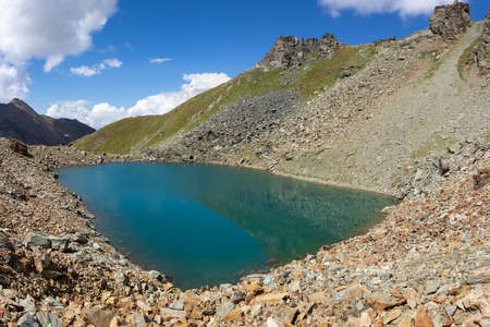 Hiking trail in Aosta valley, Cogne, Italy. Alpine lake of Garin. Photo taken at an altitude of 2900 meters.の写真素材