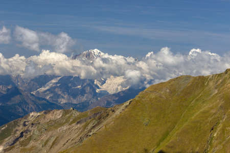 Hiking in Aosta valley, Italy. View of Mont Blanc Massif with cloudy sky. Telephoto from Mount Creya (Cogne valley).の写真素材