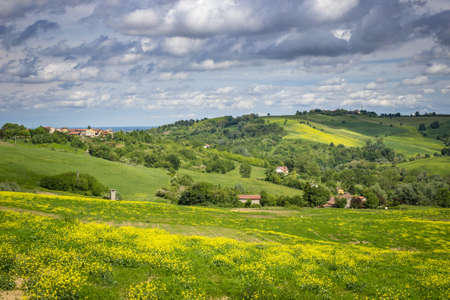 Spring colors in the Monferrato hills, Piedmont, Italy. Landscape with cloudy sky.の写真素材