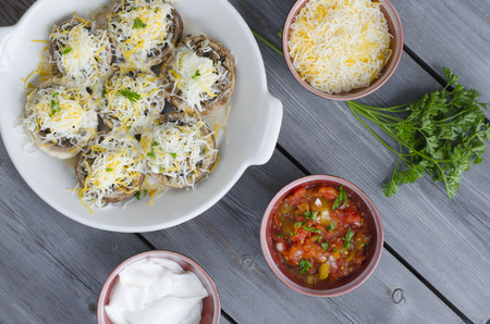 Baked mushroom caps stuffed with fried mushrooms onion cheese and spices.
