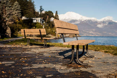 two benches in front of a lakeの写真素材