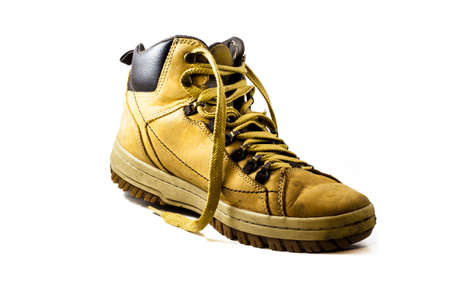 used yellow boot isolated on white background