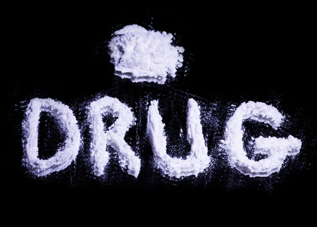 Word Drug and a pile of white drug on a mirrorの写真素材