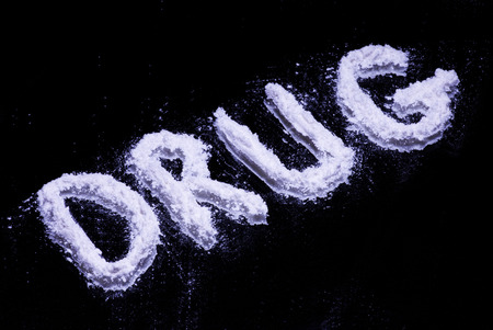Word Drug on a mirror written with white powder
