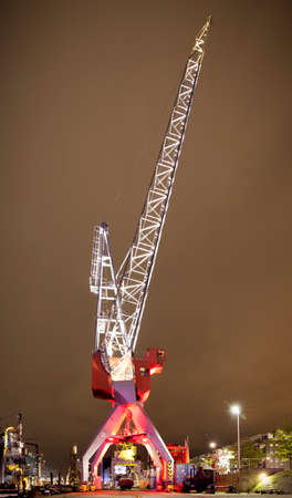 Big and illuminated crane in the old port of Rotterdamの写真素材