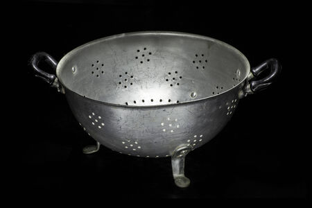 Old colander isolated on a black background. Studio shotの写真素材