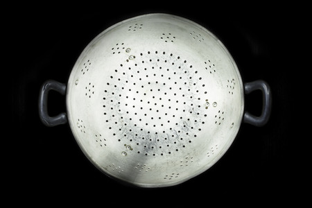 Old colander isolated on a black background. Studio shotの写真素材
