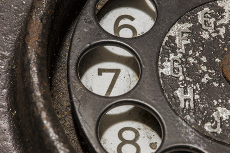 Old black telephone. Close-up of a rotary dial
の写真素材