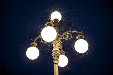 Old street lamp with mosquitoes at nightの写真素材