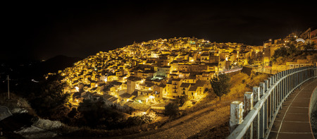 Nocturnal panoramic view of Prizzi, a typical village located in the middle of the Sicilyの写真素材