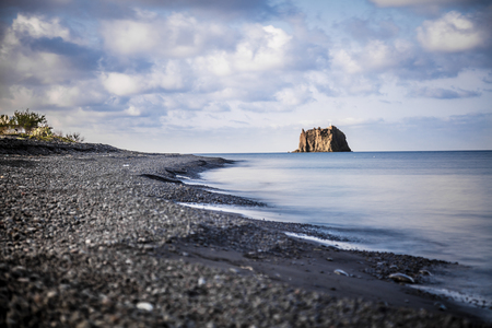 The small promontory of Strombolicchio from Stromboli's black beach