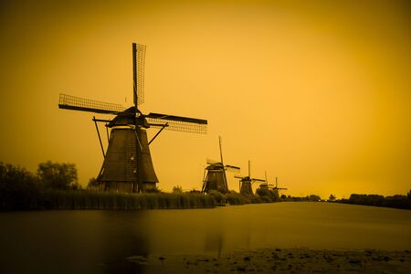 Picturesque landscape with windmills in Kinderdijk (Holland) at sunsetの写真素材