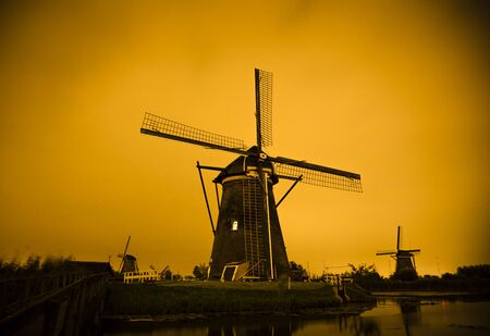 Picturesque landscape with windmills in Kinderdijk (Holland) at sunsetの写真素材
