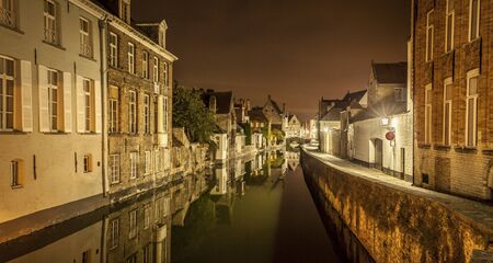 Romantic nocturnal view of a canal in Bruges. Night view of famous Bruges city view, Belgium, nightshot of Bruges canals, houses on canalの写真素材