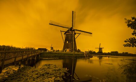 Picturesque landscape with windmills in Kinderdijk (Holland) at sunsetの写真素材
