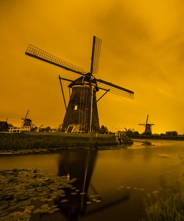 Picturesque landscape with windmills in Kinderdijk (Holland) at sunsetの写真素材