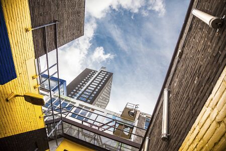 Urban view in Rotterdam with yellow walls and a skyscraperの写真素材