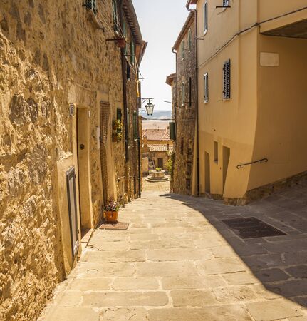 A typical small street of Castiglione d'Orcia, an ancient village in Tuscany, Italyの写真素材