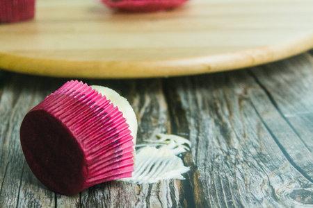 Bitten muffin on foreground hold by handの写真素材