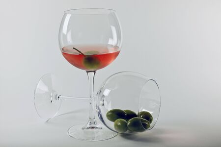 Two glasies in cristal white aperitiv and olivesの写真素材