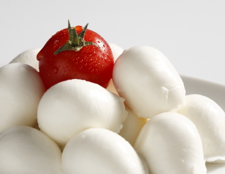mozzarella and one cherry tomatoの写真素材