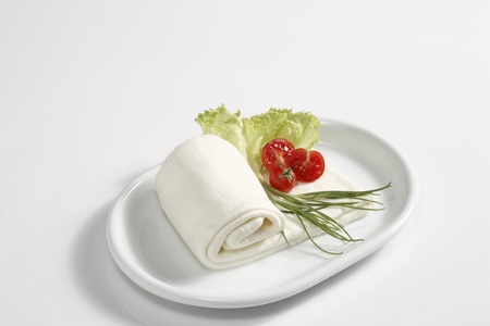 a foil of mozzarella(an italian kind of cheese) with tomatoes and lettuceの写真素材