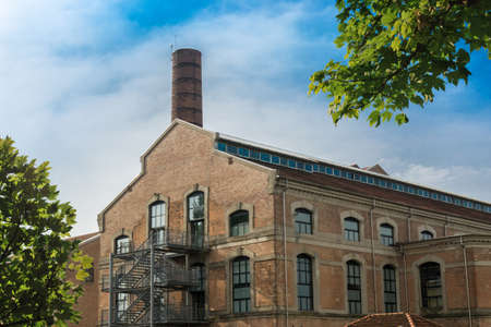 Industrial building with a tower and treesの写真素材