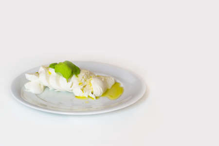 Slices of italian mozzarella with leaves of basilの写真素材
