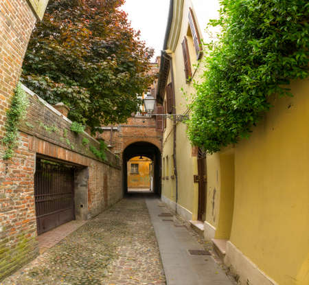 Small ancient street in the old downtown of Ferrara Italy