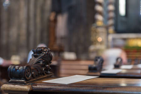 Detail of a bench inside the Trento Cathedral in Italyの写真素材