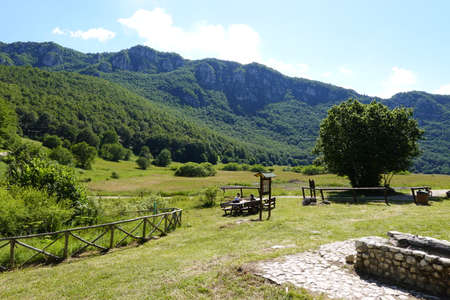 Green valley with people doing a picnicの写真素材