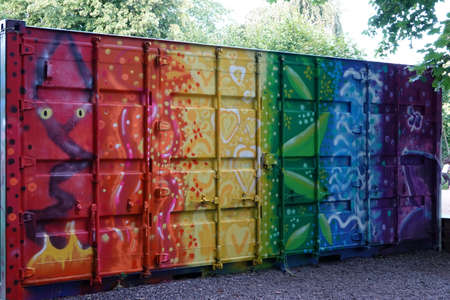 Container with colorful graffiti in orange, yellow, green blue and violetの写真素材