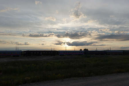 Sunset with clouds with a train in the backgroundの写真素材